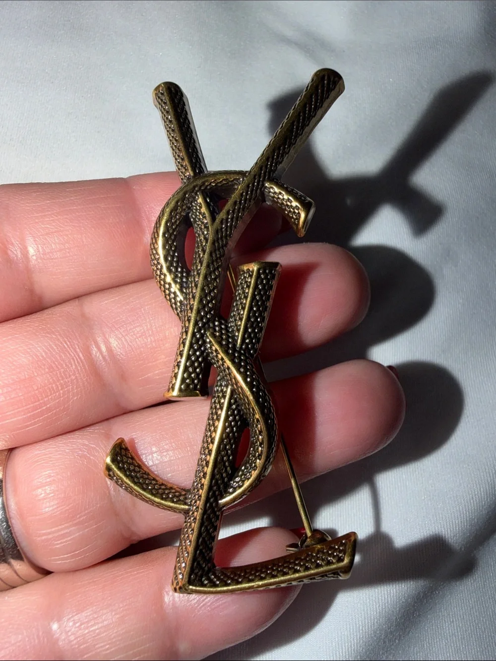 Saint Laurent Cassandre textured snake-pattern logo brooch
